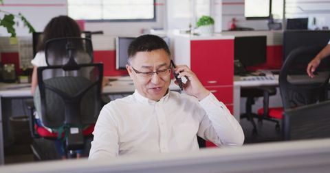 Confident Businessman on Phone Call in Modern Office Space