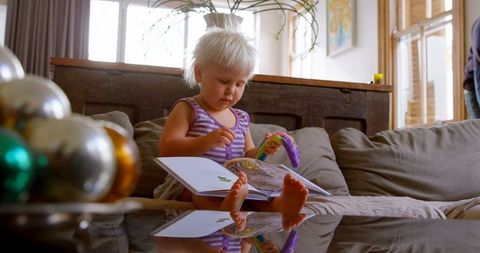 Young Girl Enthralling Reading Storybook in Cozy Living Room