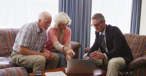 Senior couple consulting business professional living room meeting