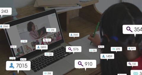 Student writing wearing headset using laptop for remote learning overlay engagement badges