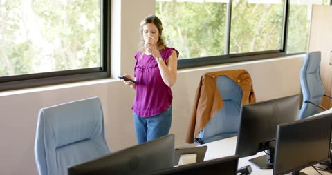 Casual Businesswoman Drinking Coffee While Exploring Smartphone