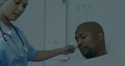 Nurse Assisting Patient in Hospital Room With IV Drip