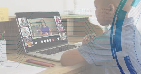 Remote learning child leaning over laptop at home desk with digital circuitry overlay