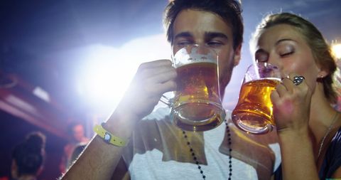 Young Couple Enjoying Drinks at a Vibrant Party
