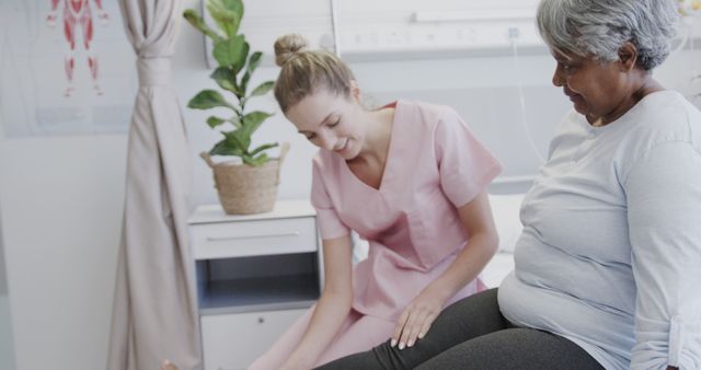 Nurse helping elderly patient perform physical therapy exercises at healthcare facility. Useful for articles on elderly care, physical rehabilitation, healthcare services, and patient recovery.