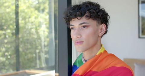 Pensive Man Wearing Rainbow Flag Looking at Nature