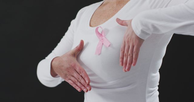 Woman Wearing Pink Ribbon Performing Breast Cancer Self-Exam - Download Free Stock Images Pikwizard.com