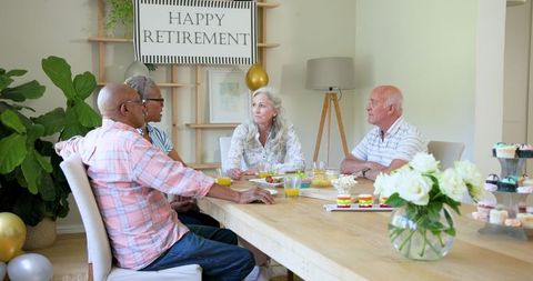 Elderly friends celebrating retirement at home