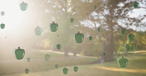 Green Pepper Icons Overlaying Lush Park Scene