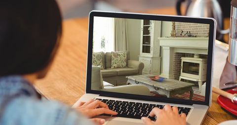 Person Viewing Modern Living Room Interior Design on Laptop - Download Free Stock Images Pikwizard.com