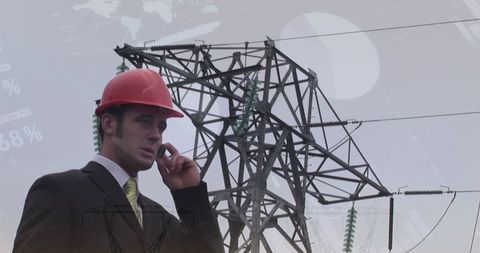 Businessman with hard hat discussing power infrastructure