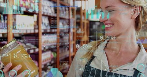 Smiling grocery clerk inspecting jar with augmented reality data overlay, retail analytics