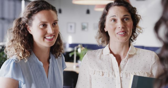 Two Professional Women Engaging in a Business Conversation - Download Free Stock Images Pikwizard.com