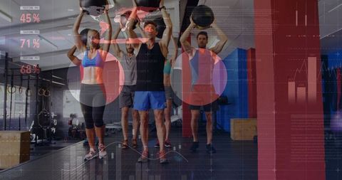Group performing overhead medicine ball presses with fitness analytics overlay