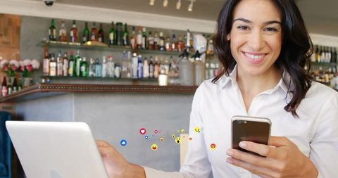 Smiling Professional Woman Using Phone at Cafe for Social Engagement