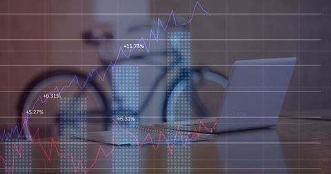 Office Desk with Laptop Overlayed with Statistical Graphs