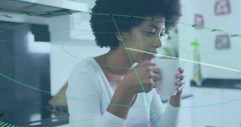 Curly-haired woman enjoying morning drink in modern kitchen