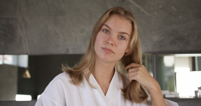 Woman Touching Hair in Bathroom Conveys Self-care and Grooming - Download Free Stock Images Pikwizard.com