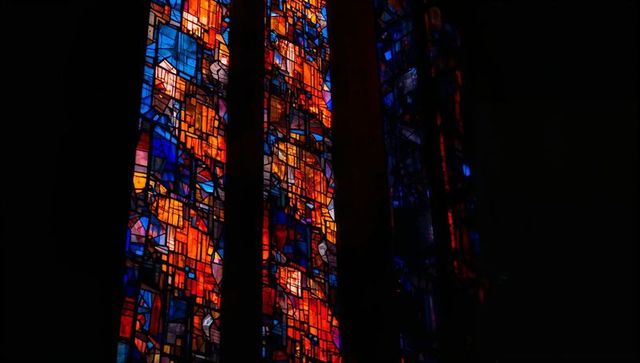 Stained Glass Panels Illuminating Chapel with Vibrant Mosaic Colors