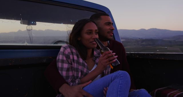 Couple Relaxing in Pickup Truck at Sunset Holding Beverage - Download Free Stock Images Pikwizard.com