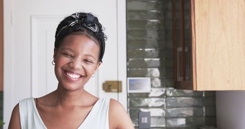 Smiling Young African American Woman at Home Interior