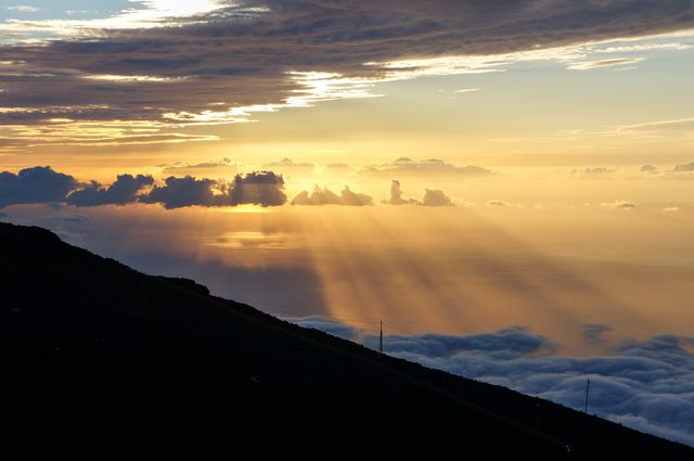 Glorious Sunrise Over Hills with Dramatic Rays Piercing Through Clouds - Download Free Stock Photos Pikwizard.com