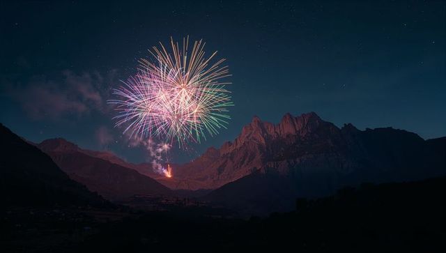Spectacular colorful fireworks over majestic mountain peaks