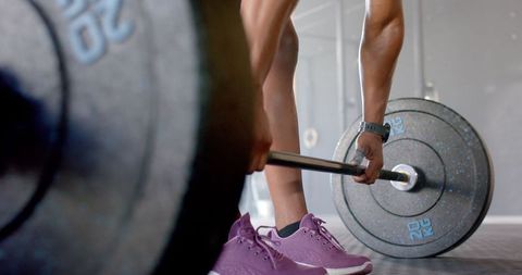 Woman Lifting Barbell in Gym Wearing Vibrant Purple Sneakers - Download Free Stock Images Pikwizard.com