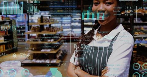 Smiling bakery staff in striped apron crossing arms at pastry counter with data overlay