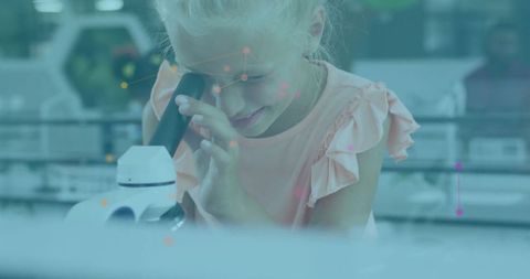 Curious child exploring science through microscope