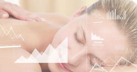 Woman receiving relaxing spa massage while digital wellness data overlay conveying calm