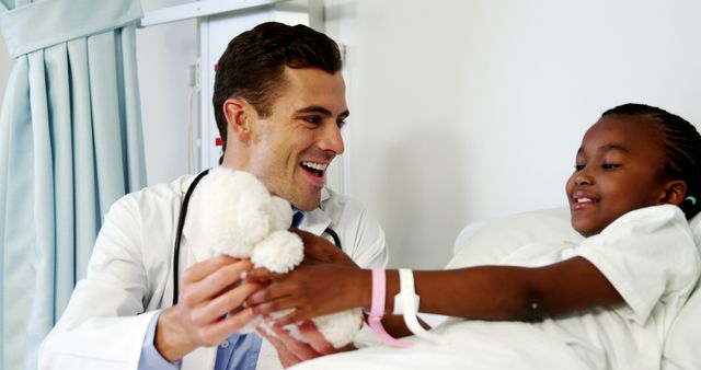 Doctor Comforting Child Patient in Hospital Room with a Toy - Download Free Stock Images Pikwizard.com