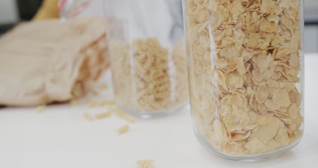 Storage Jars Filled with Cornflakes and Cereals on White Kitchen Counter - Download Free Stock Images Pikwizard.com