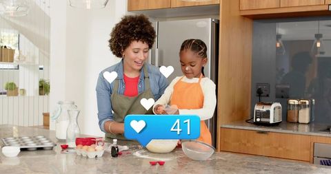 Woman guiding child mixing batter in bright modern kitchen while baking together