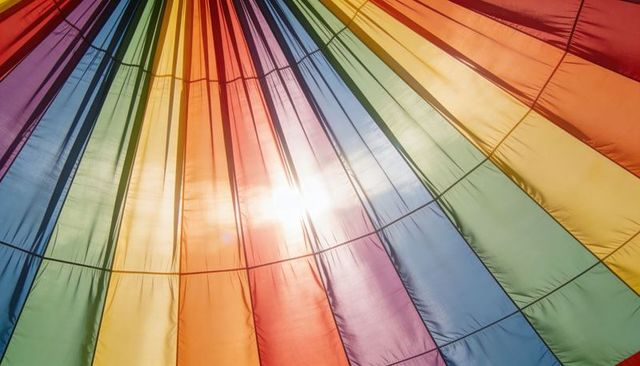 Glowing Rainbow Canopy Radiating Sunlight Through Translucent Fabric with Circular Seams