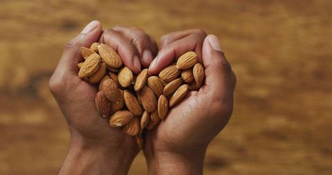 Hands Holding Almonds on Wooden Background Illustrating Plant-Based Diet - Download Free Stock Images Pikwizard.com