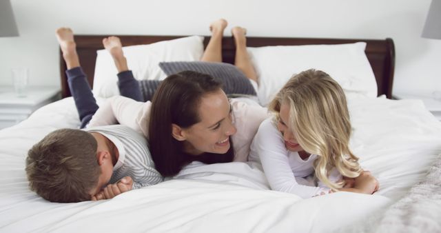 Happy Mother and Children Smiling Together on Bed - Download Free Stock Images Pikwizard.com