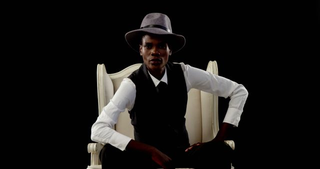 Confident Fashionable Black Man in Hat Sitting on Armchair - Download Free Stock Images Pikwizard.com