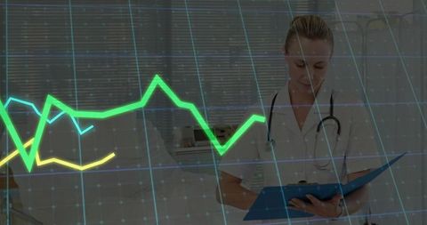 Doctor reviewing medical data with digital graphics overlay