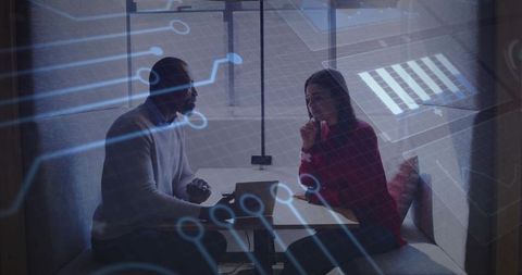 Colleagues Collaborating on Technological Innovation Project in Office