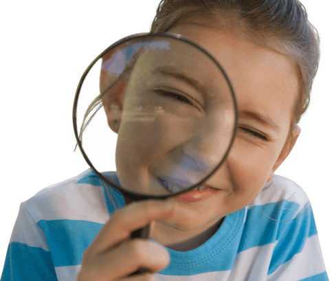 Curious little girl peering through transparent magnifying glass outdoors