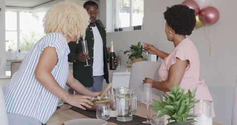 Friends Stylishly Preparing Elegant Dinner Party at Home