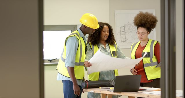 Diverse Team Analyzing Architectural Plans in Office - Download Free Stock Images Pikwizard.com