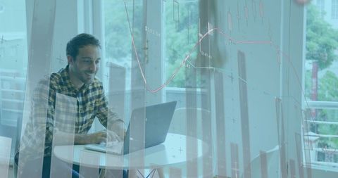 Man Analyzing Financial Data on Laptop with Graphs Overlaid