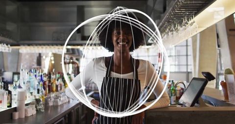 Bartender standing confidently in modern bar with stylish apron