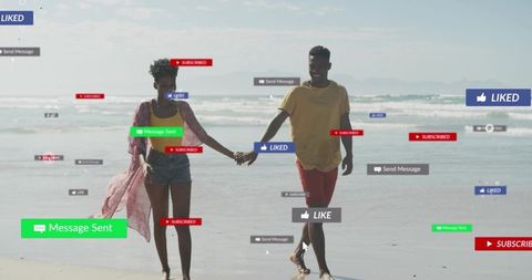 Young couple walking on beach holding hands with floating social media like badges