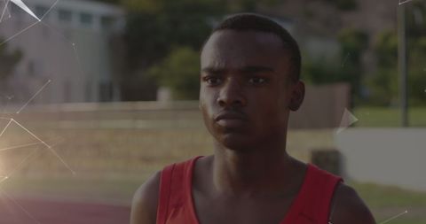 Determined teen athlete preparing for race on track field