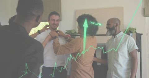 Team helping colleague adjust shirt collar celebrating career growth and office success