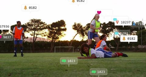 Women Soccer Players Training with Notification Icons at Sunset