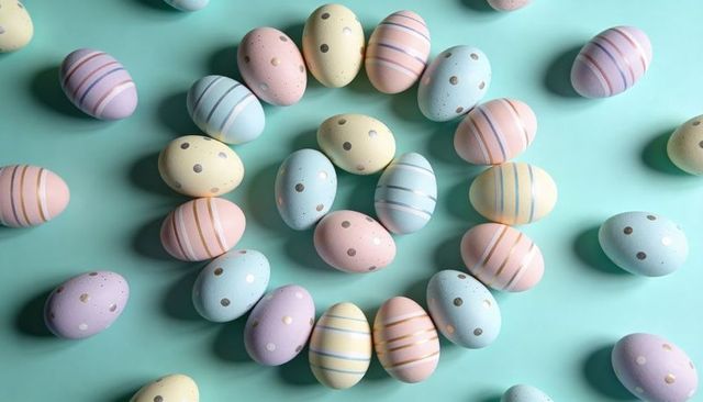 Pastel Easter Eggs Forming Spiral on Mint Background with Gold Accents and Stripes